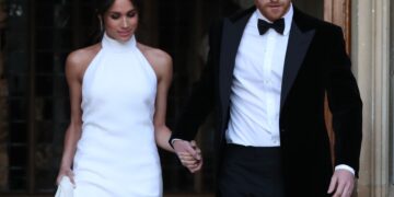 The newly married Duke and Duchess of Sussex, Meghan Markle and Prince Harry, leaving Windsor Castle after their wedding to attend an evening reception at Frogmore House, hosted by the Prince of Wales. *** Local Caption *** .