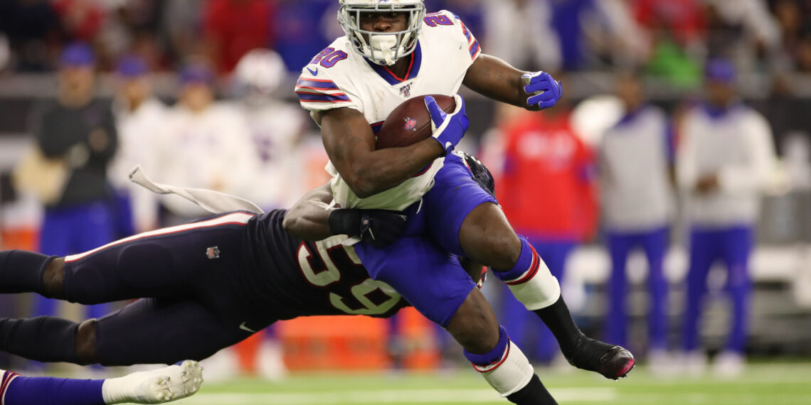 HOUSTON, TEXAS - JANUARY 04:  Frank Gore #20 of the Buffalo Bills runs the ball against Whitney Mercilus #59 of the Houston Texans during the third quarter of the AFC Wild Card Playoff game at NRG Stadium on January 04, 2020 in Houston, Texas. (Photo by Christian Petersen/Getty Images)