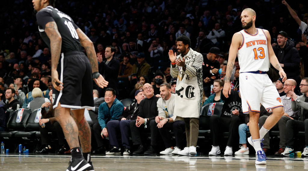 NEW YORK, NEW YORK - MARCH 13: Kyrie Irving of the Brooklyn Nets (C) claps as James Johnson #16 of the Brooklyn Nets and Evan Fournier #13 of the New York Knicks play during the second half at Barclays Center on March 13, 2022 in the Brooklyn borough of New York City. The Nets won 110-107. NOTE TO USER: User expressly acknowledges and agrees that, by downloading and or using this photograph, User is consenting to the terms and conditions of the Getty Images License Agreement. (Photo by Sarah Stier/Getty Images)