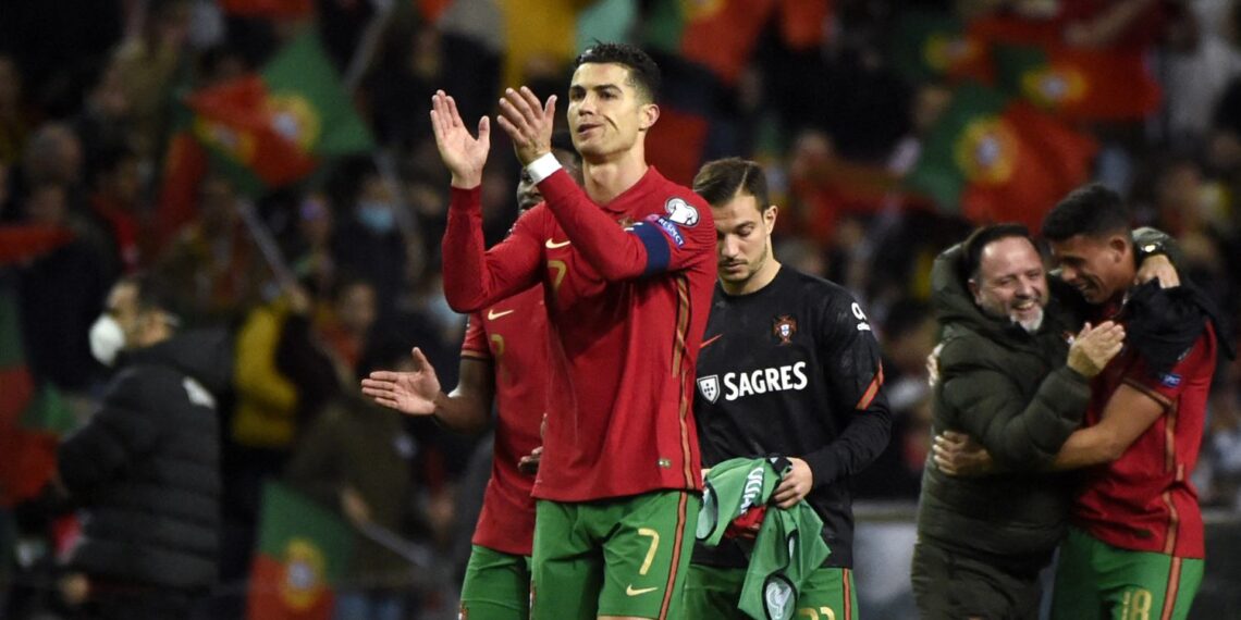 Portugal's forward Cristiano Ronaldo waves to supporters at the end of the World Cup 2022 qualifying semi-final first leg football match between Portugal and Turkey at the Dragao stadium in Porto on March 24, 2022. (Photo by MIGUEL RIOPA / AFP)