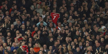 Liverpool fans applaud on the seventh minute in support for Manchester United's Cristiano Ronaldo and his family during the English Premier League soccer match between Liverpool and Manchester United at Anfield stadium in Liverpool, England, Tuesday, April 19, 2022. (AP Photo/Jon Super)