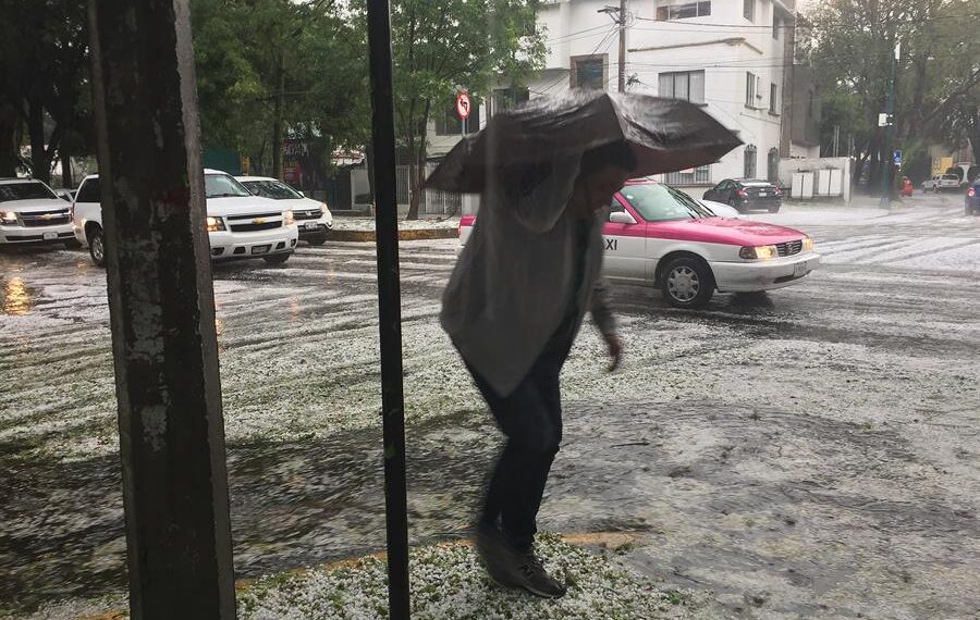 Fotografía de archivo de una persona que camina bajo la lluvia por una avenida en Ciudad de México (México). EFE/Jorge Núñez