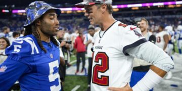 Tampa Bay Buccaneers quarterback Tom Brady (12) talks with Indianapolis Colts cornerback Stephon Gilmore (5) after an NFL preseason football game in Indianapolis, Saturday, Aug. 27, 2022. The Colts defeated the Buccaneers 27-10. (AP Photo/AJ Mast)