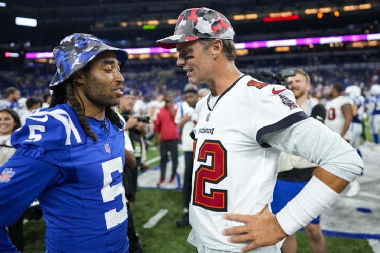 Tampa Bay Buccaneers quarterback Tom Brady (12) talks with Indianapolis Colts cornerback Stephon Gilmore (5) after an NFL preseason football game in Indianapolis, Saturday, Aug. 27, 2022. The Colts defeated the Buccaneers 27-10. (AP Photo/AJ Mast)