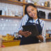 Restaurant worker on tablet, phone call and making food payment, delivery or crm conversation with a customer. Business owner or manager of fast food store, coffee shop or cafe shopping for supplies.