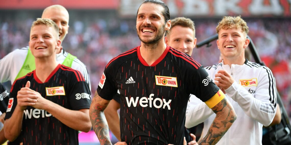 Union Berlin's Austrian defender Christopher Trimmel (C) and his teammates celebrate after the German first division Bundesliga football match between FC Cologne and 1 FC Union Berlin in Cologne, western Germany, on September 11, 2022. - DFL REGULATIONS PROHIBIT ANY USE OF PHOTOGRAPHS AS IMAGE SEQUENCES AND/OR QUASI-VIDEO (Photo by UWE KRAFT / AFP) / DFL REGULATIONS PROHIBIT ANY USE OF PHOTOGRAPHS AS IMAGE SEQUENCES AND/OR QUASI-VIDEO (Photo by UWE KRAFT/AFP via Getty Images)