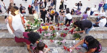 Familiares y amigos de víctimas de feminicidio colocan cruces, flores y veladoras en un altar en recuerdo de ellas en la ciudad de Oaxaca (Foto: EFE)
