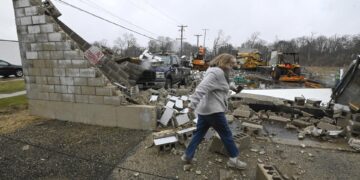 Una mujer pasa frente a un negocio destruido tras un tornado en Belvidere, Illinois, EE.UU,  este 1 de abril de 2023. EFE/EPA/Matt Barton