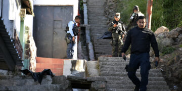 Policías acordonan la zona donde fue encontrado un cuerpo mutilado, el 22 de marzo de 2023, en Tegucigalpa (Honduras). EFE/ STR