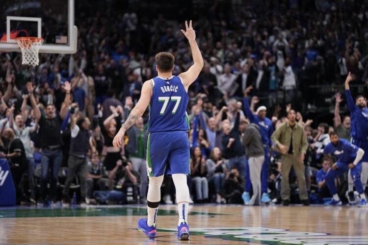 Dallas Mavericks guard Luka Doncic (77) gestures while walking up the court during the second half of the team's NBA basketball game against the Sacramento Kings in Dallas, Wednesday, April 5, 2023. (AP Photo/Sam Hodde)