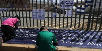 Migrantes escriben pancartas durante una manifestación para exigir justicia por 40 indocumentados que murieron por incendio en el Instituto Nacional de Migración (INM), en Ciudad Juárez Foto de EFE/Luis Torres.