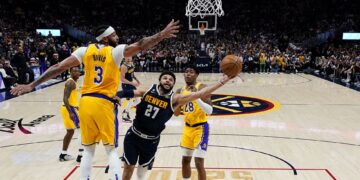 Denver Nuggets guard Jamal Murray (27) shoots under Los Angeles Lakers forward Anthony Davis (3) during the first half of Game 2 of the NBA basketball Western Conference Finals series, Thursday, May 18, 2023, in Denver. (AP Photo/Jack Dempsey)