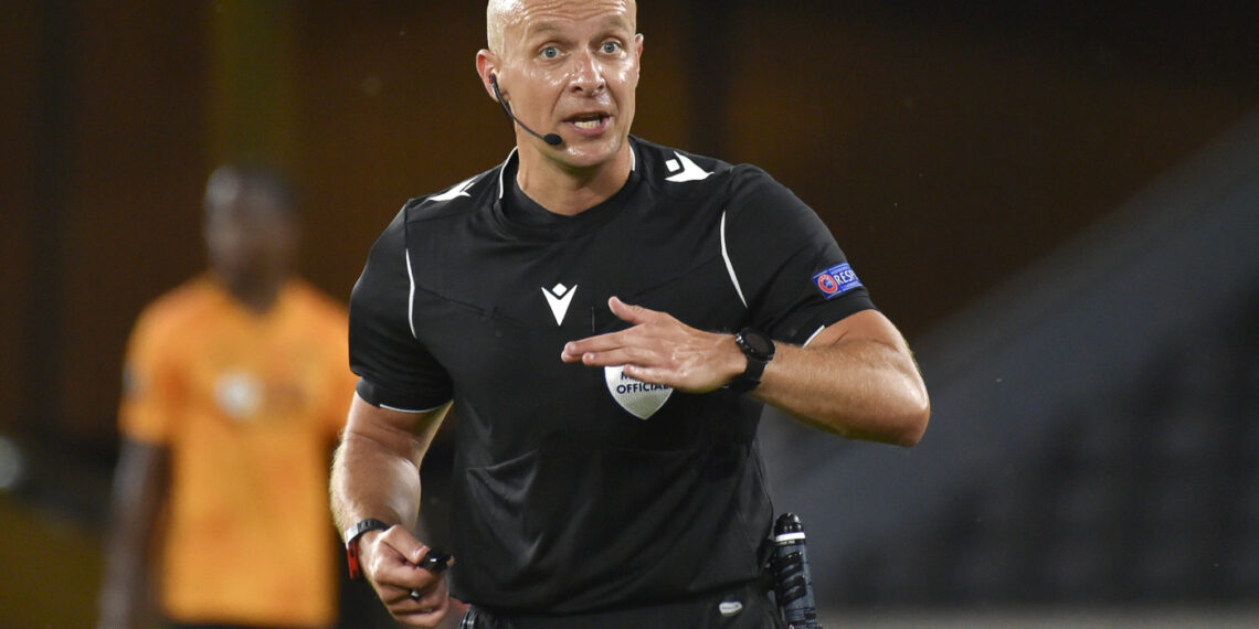 Referee Szymon Marciniak reacts during the Europa League round of 16 second leg soccer match between Wolves and Olympiakos at Molineux Stadium in Wolverhampton, England, Thursday, Aug. 6, 2020. (AP Photo/Rui Vieira)