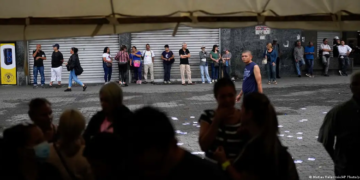 Electores esperan afuera de un centro de votación de primarias en Caracas (22.10.2023)Imagen: Matias Delacroix/AP Photo/picture alliance