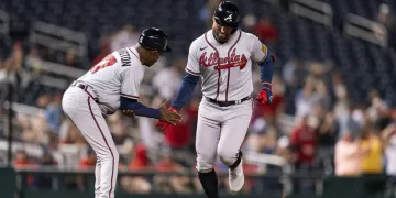 Atlanta Braves' Kevin Pillar, right, celebrates with third base coach Ron Washington, left, after hitting a two-run home run during the fourth inning of the second game of a baseball doubleheader against the Washington Nationals, Sunday, Sept. 24, 2023, in Washington. (AP Photo/Stephanie Scarbrough)