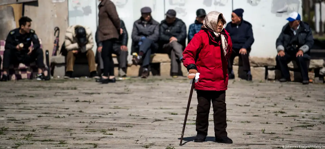 Mujeres y hombres de la tercera edad en una calle de ShanghaiImagen: Johannes Eisele/AFP/Getty Images