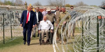El expresidente Donald Trump habla con el gobernador de Texas, Greg Abbott, durante una visita a la frontera entre Estados Unidos y México el jueves en Eagle Pass, Texas. Eric Gay/AP