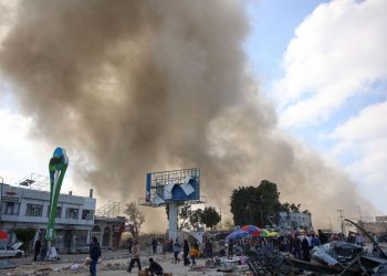 Palestinians look at smoke billowing during Israeli bombardment on the Firas market area in Gaza City on April 11, 2024, amid the ongoing conflict between Israel and the Palestinian Hamas group. (Photo by AFP)