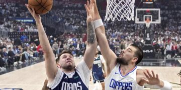 Dallas Mavericks guard Luka Doncic, left, shoots as Los Angeles Clippers center Ivica Zubac defends during the first half in Game 5 of an NBA basketball first-round playoff series Wednesday, May 1, 2024, in Los Angeles. (AP Photo/Mark J. Terrill)